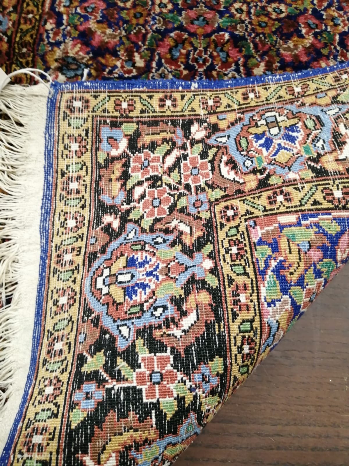 A North West Persian part silk blue ground rug, 89cm x 58cm